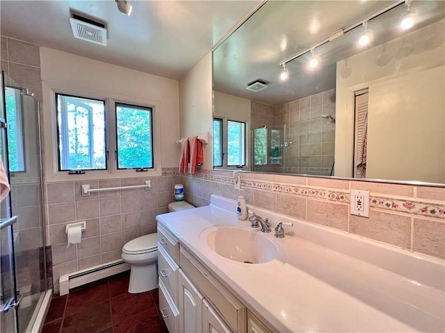 bathroom with vanity, tile patterned flooring, tile walls, walk in shower, and a baseboard radiator