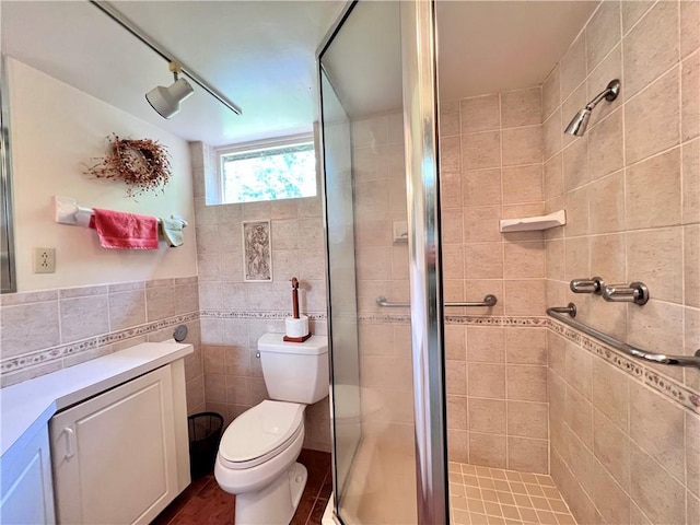 bathroom with an enclosed shower, tile patterned floors, toilet, and tile walls