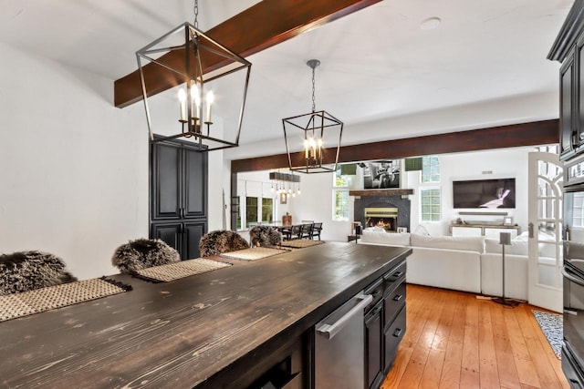 kitchen featuring butcher block counters, light hardwood / wood-style flooring, and pendant lighting