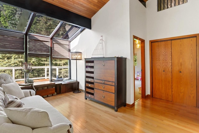 interior space featuring beam ceiling, wooden ceiling, high vaulted ceiling, and light hardwood / wood-style flooring