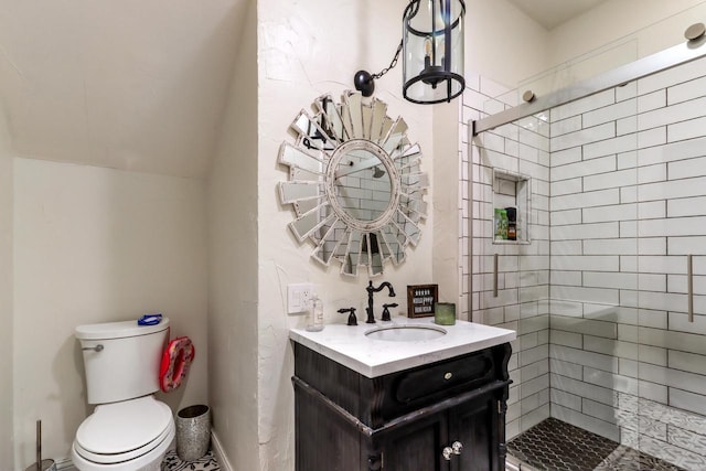 bathroom with a shower with door, vanity, and toilet