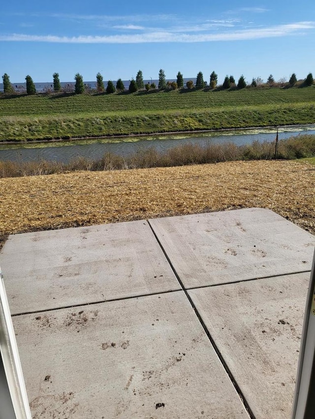 view of yard with a rural view and a water view