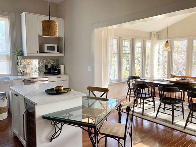 dining room featuring wine cooler, dark hardwood / wood-style flooring, and vaulted ceiling