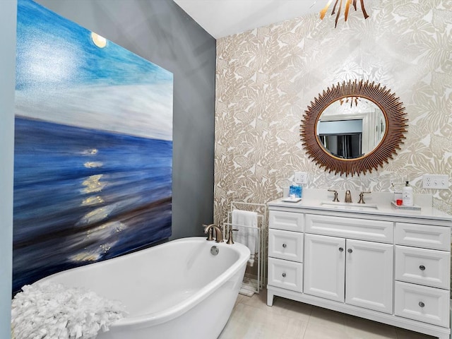 bathroom featuring tile patterned floors, vanity, and a bath