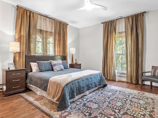 bedroom with ceiling fan and light hardwood / wood-style flooring