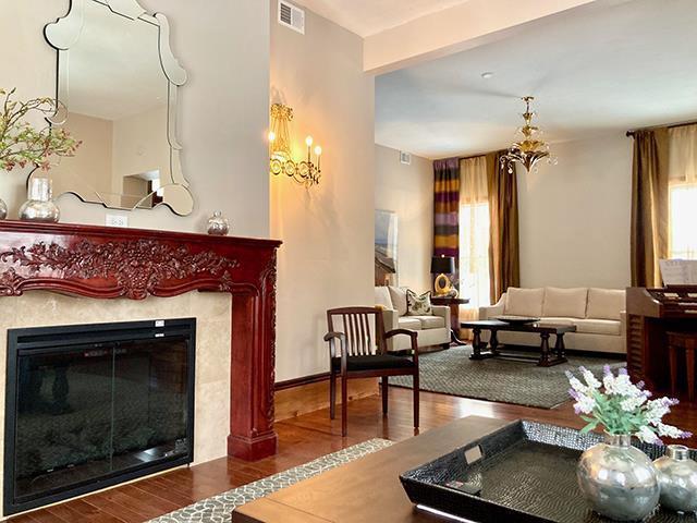 living room featuring hardwood / wood-style floors, beam ceiling, and a fireplace