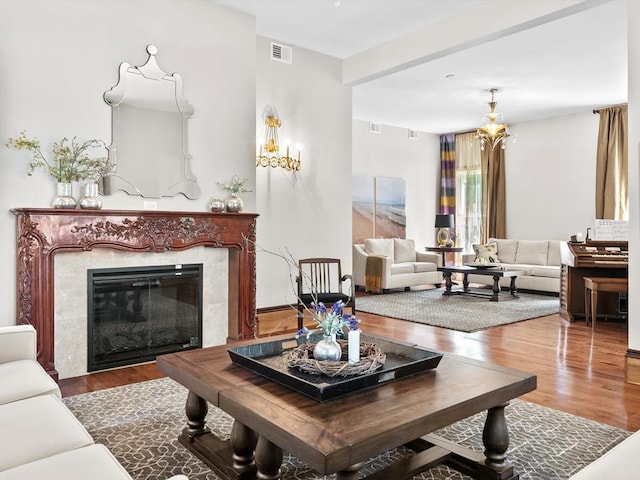 living room with wood-type flooring and a fireplace