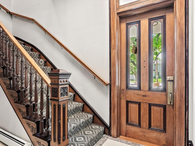 view of exterior entry with a baseboard radiator