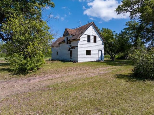 view of property exterior with a lawn