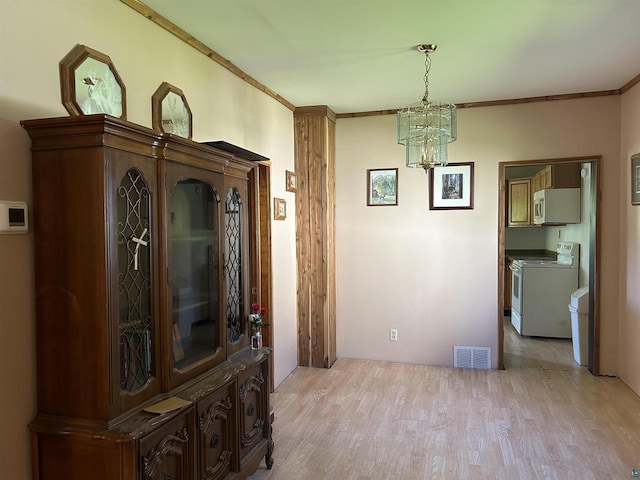 157 E 2nd St, Glidden, WI 54527 - dining area featuring light hardwood / wood-style floors, crown molding, and an inviting chandelier
