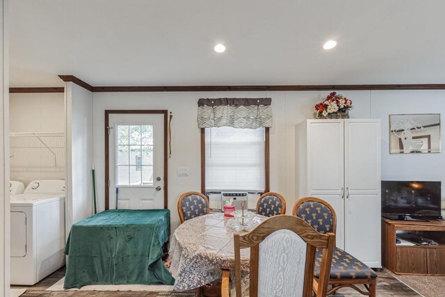 dining area featuring washer and dryer, light wood-type flooring, cooling unit, and crown molding