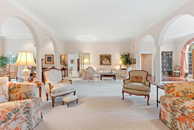 living room featuring light carpet, ornate columns, and crown molding