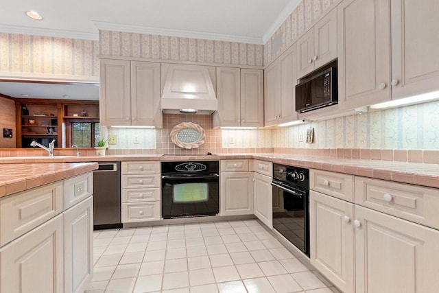 kitchen featuring tile counters, white cabinets, black appliances, and custom exhaust hood