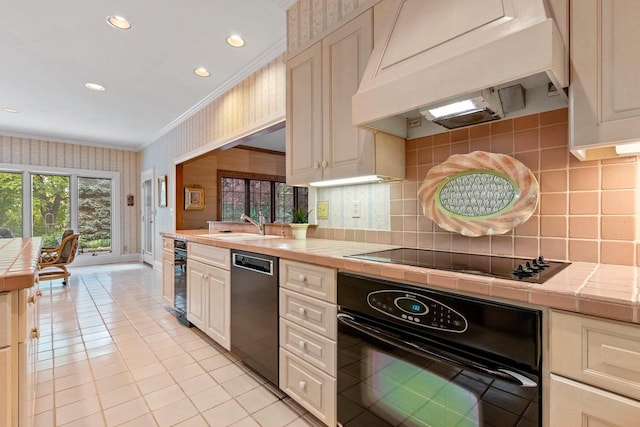 kitchen with tile counters, light tile patterned flooring, black appliances, and custom range hood