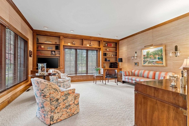 living room with wood walls, built in features, ornamental molding, and carpet floors