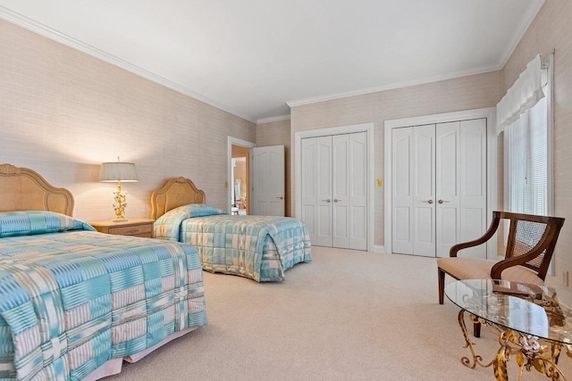 bedroom with multiple closets, carpet, and ornamental molding