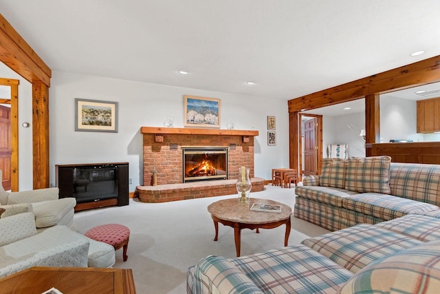 living room with carpet and a brick fireplace