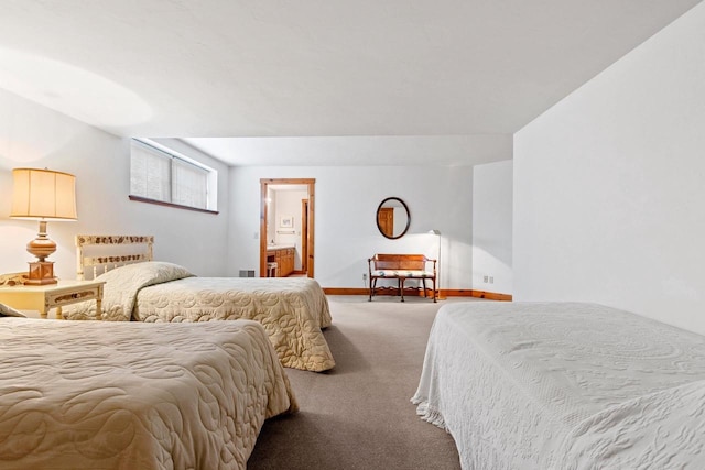 carpeted bedroom featuring ensuite bath