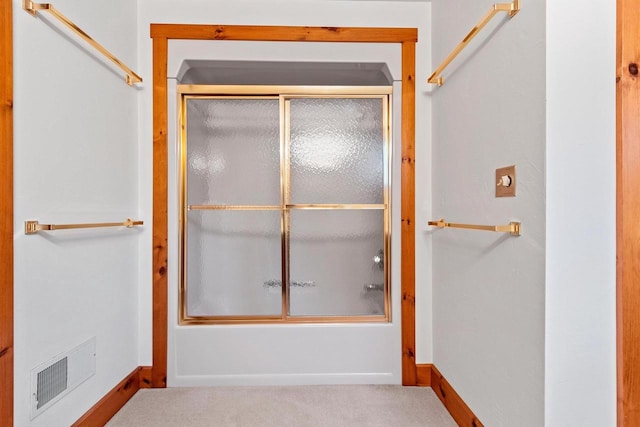 bathroom featuring bath / shower combo with glass door