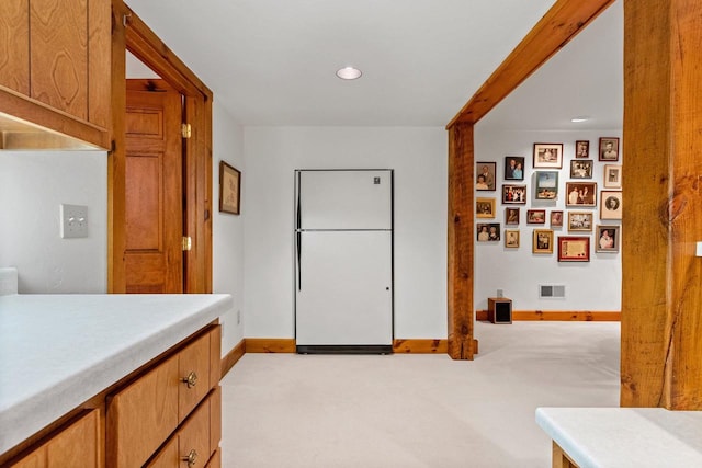 kitchen with light carpet and white fridge