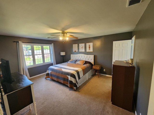 bedroom with ceiling fan and light colored carpet