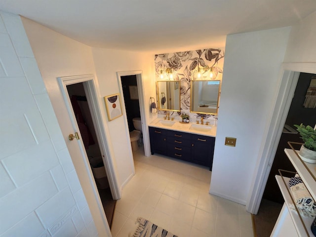 bathroom with tile patterned floors, vanity, and toilet