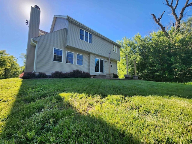 rear view of house featuring a lawn