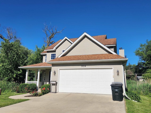 view of front of house with covered porch and a garage