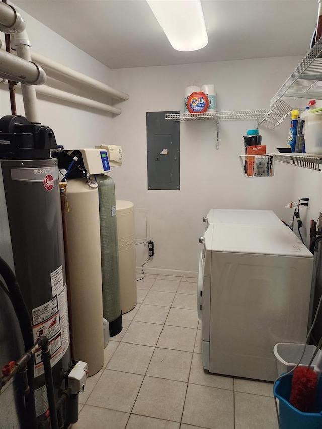 clothes washing area featuring light tile patterned floors, washing machine and dryer, and electric panel