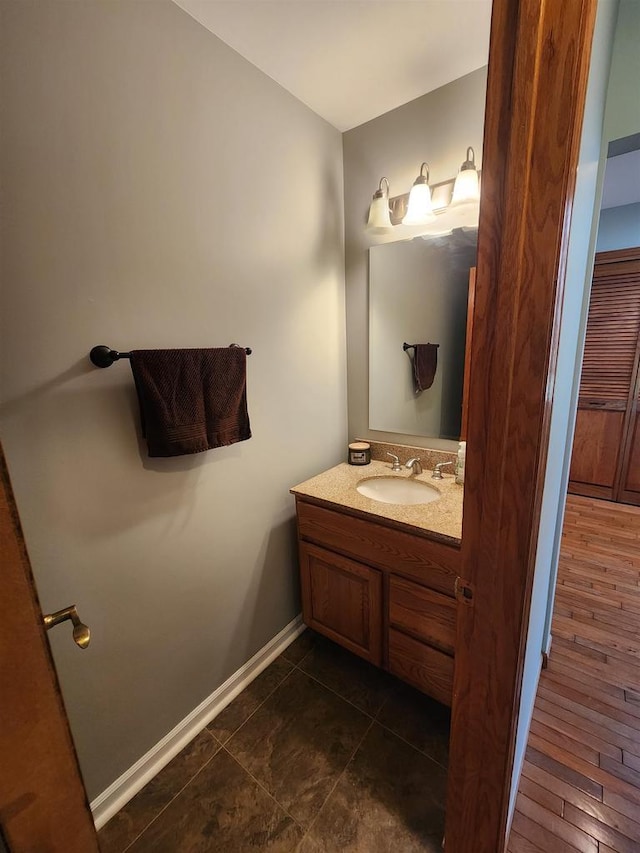 bathroom featuring hardwood / wood-style flooring and vanity