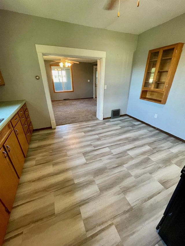 carpeted dining area featuring ceiling fan