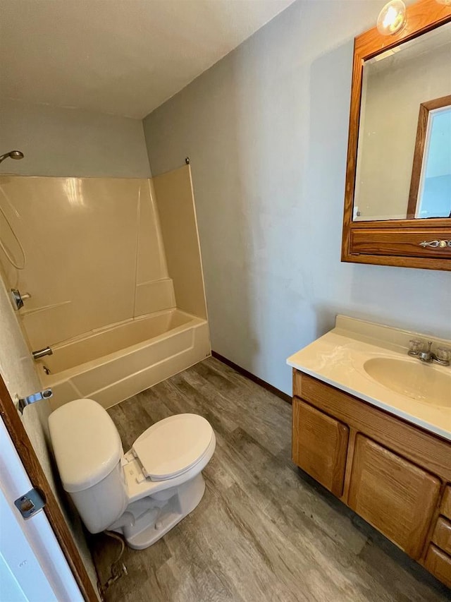 full bathroom with shower / bathing tub combination, wood-type flooring, vanity, and toilet