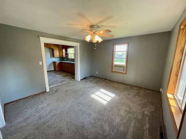 unfurnished room featuring carpet, ceiling fan, and cooling unit