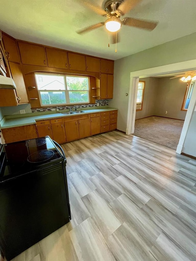 kitchen with light carpet, extractor fan, and black electric range