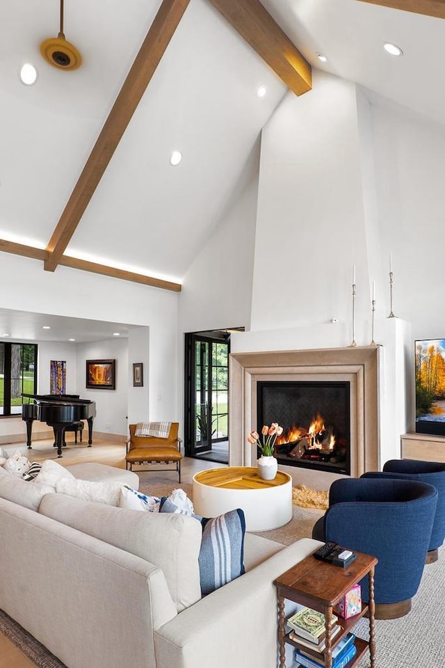 living room with beamed ceiling and high vaulted ceiling