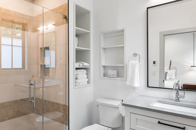 bathroom with vanity, toilet, and walk in shower