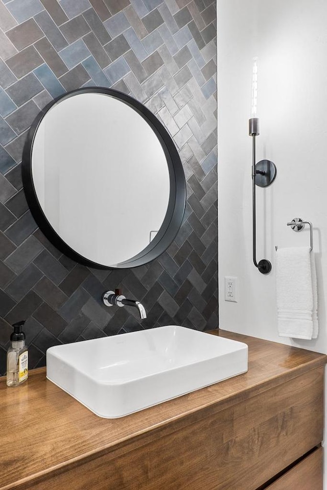 bathroom with tasteful backsplash and sink