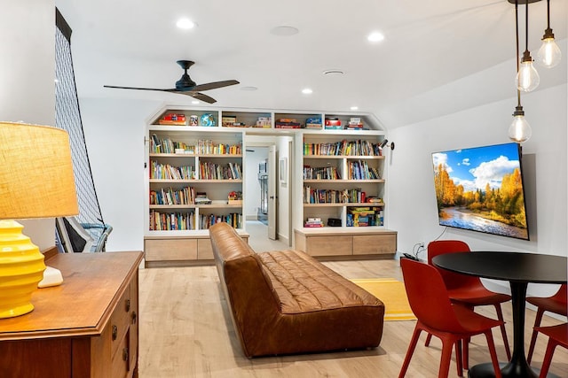 living area featuring vaulted ceiling, ceiling fan, and light hardwood / wood-style floors