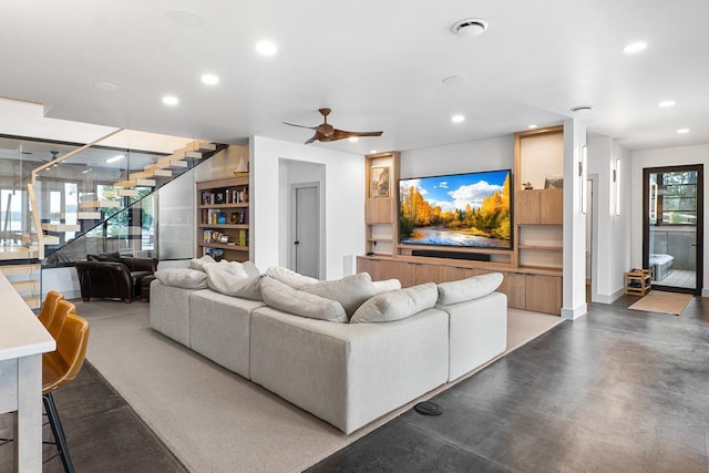 living room with concrete floors and ceiling fan