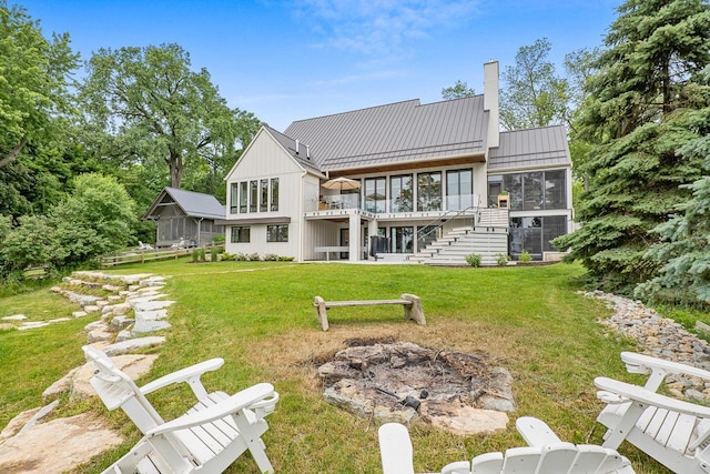 back of house featuring a sunroom and a yard