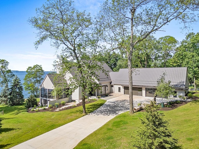 view of front of home with a garage and a front yard