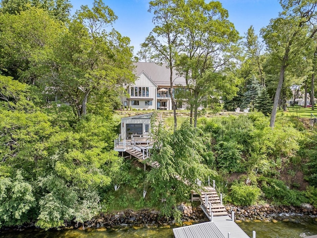 back of property featuring a water view