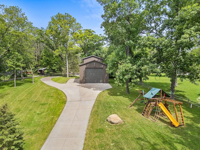 view of community with a playground, an outbuilding, and a lawn