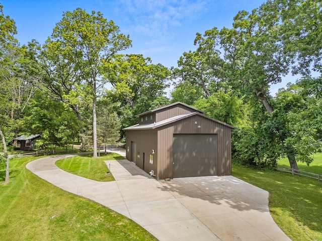 exterior space with a garage, a lawn, and an outdoor structure