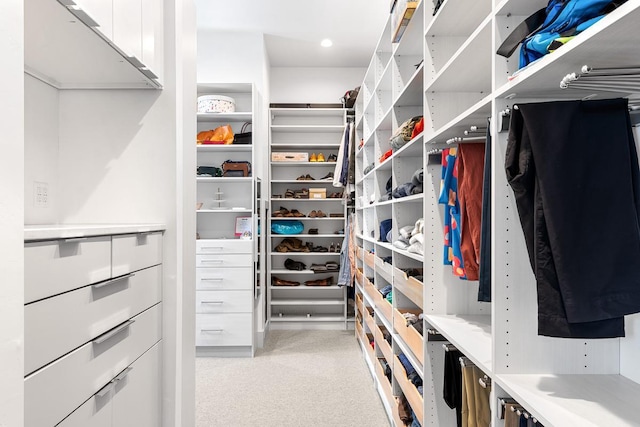 walk in closet featuring light carpet