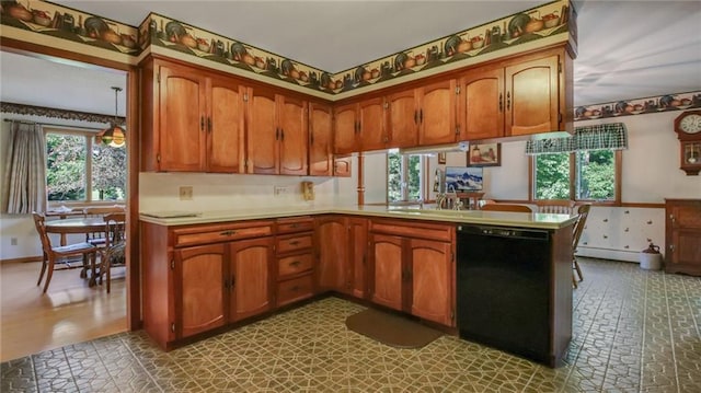 kitchen featuring sink, kitchen peninsula, black dishwasher, and a baseboard radiator