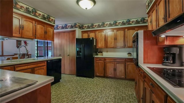 kitchen with sink, extractor fan, and black appliances