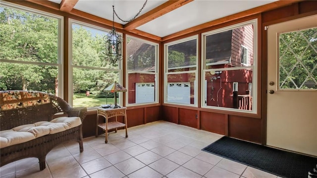 sunroom / solarium featuring beamed ceiling and plenty of natural light