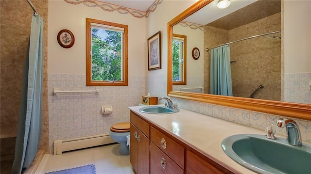 bathroom with tile patterned flooring, vanity, a baseboard radiator, and tile walls