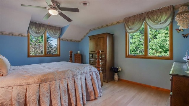 bedroom featuring ceiling fan, light wood-type flooring, and lofted ceiling